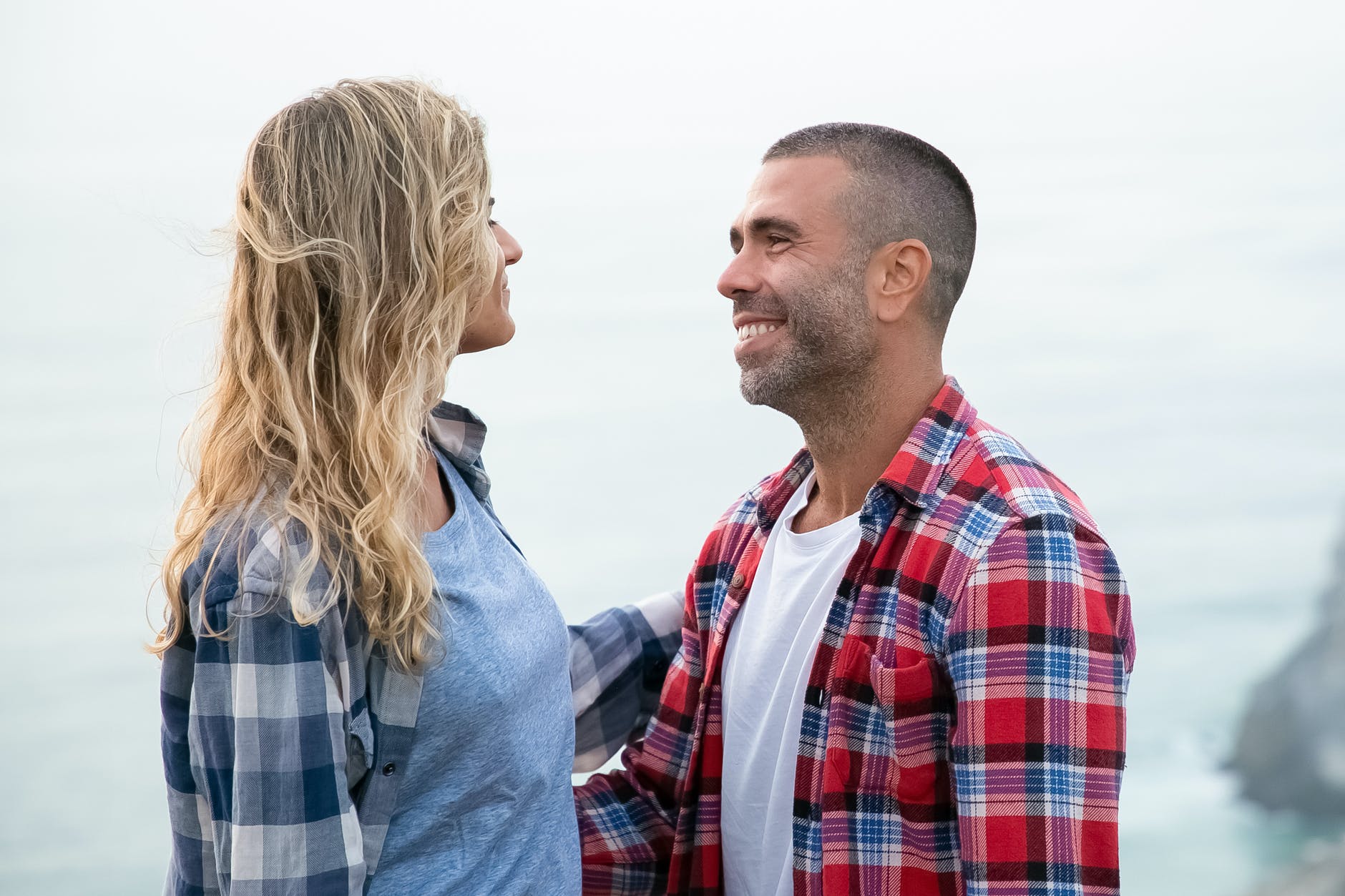 couple standing face to face and smiling